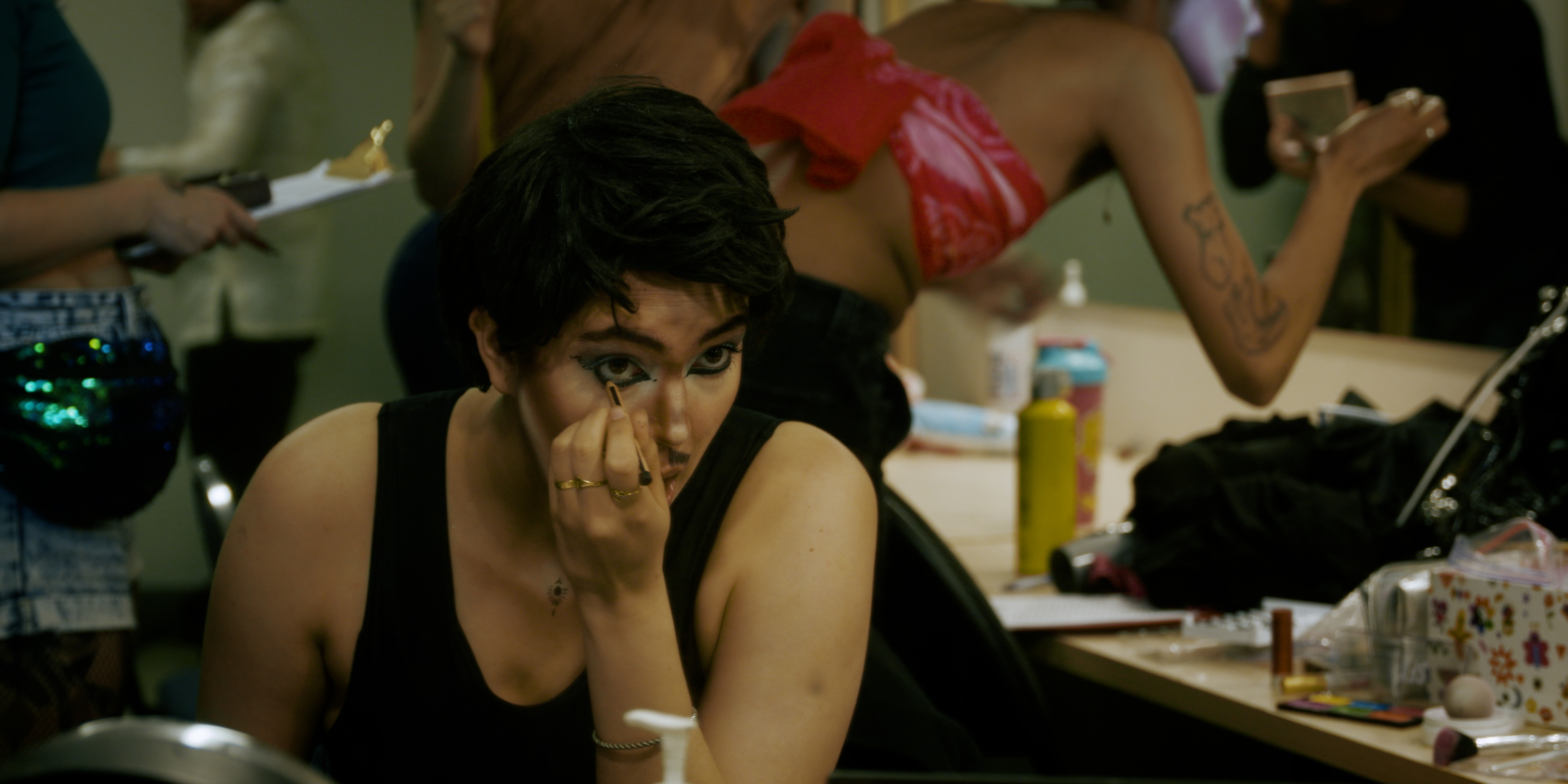 Drag king applying eye makeup backstage in Victoria Ka Raja